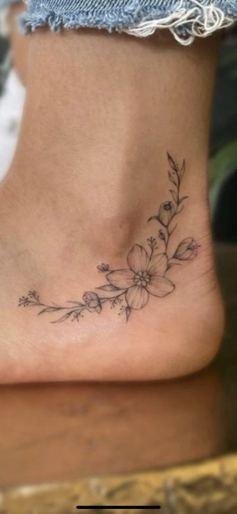 Daisy And Vine Tattoo, Small Tattoos And Placement, Wildflower Tattoo On Ankle, Under Ankle Tattoo, Small Floral Vine Tattoo, Feminine Tattoo Ideas Delicate, Under Bootie Tattoo Design, Mother Flower Tattoo, Carnation Ankle Tattoo