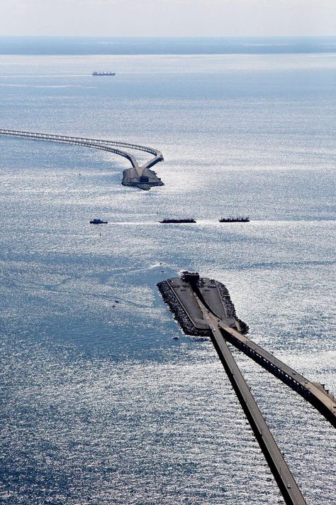 The proposed route intersected two major Atlantic shipping channels, and instead of going above the open waters, engineers put in place bridge-tunnels which could carry traffic underwater. Each tunnel portion is anchored by a series of man-made islands. Underwater Tunnel, Virginia Beach Vacation, Chesapeake Bay Bridge, Virginia Beach Virginia, Scenic Photography, Eastern Shore, Chesapeake Bay, A Bridge, Beautiful Places To Travel