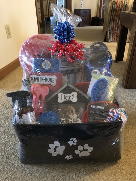 I made this one for an auction item and it had treats, a bowl, collapsable drinking bowl, dog toys, treat container, lint roller, lint brush, retractable leach, nail clippers, and more. Sold for $55. Gift Baskets For Dogs, Pet Basket For Raffle, Dog Theme Raffle Basket, Dog Auction Basket Ideas, Doggie Gift Basket Ideas, Dog Birthday Gift Basket, Dog Themed Raffle Basket Ideas, Pet Raffle Basket Ideas, Pet Basket Ideas