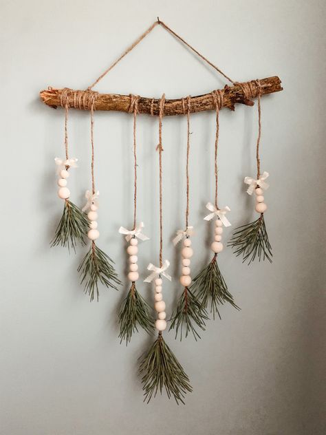 Evergreen tips, wooden balls, ribbon, twine and a stick Hanging Stick Decor, Stick With Beads Hanging, Stick Christmas Tree Branches, Mystical Crafts, Sales Ideas, Stick Christmas Tree, Christmas Sales, Window Decorations, Christmas Tree Branches