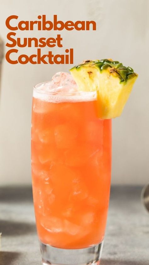 Do you dream of relaxing on a Caribbean beach, watching the sun nestle behind the captivating ocean, but are stuck in any place but there? Then a Caribbean Sunset cocktail may be the answer to your dream. This incredibly light rum drink is effortless to make. Just combine your favorite coconut rum with pineapple juice, a dash of lime juice, and grenadine for aesthetics, and off you drift into your tropical fantasy. #CaribbeanSunsetCocktail Rum Drinks With Pineapple Juice, Coconut Rum And Pineapple Juice Drinks, Light Liquor Drinks, Caribbean Sunset Cocktail, Caribbean Drinks Nonalcoholic, Carribean Drinks Cocktails, Mango Rum Drinks Recipes, Tropical Sunrise Drink, Carribean Cocktails