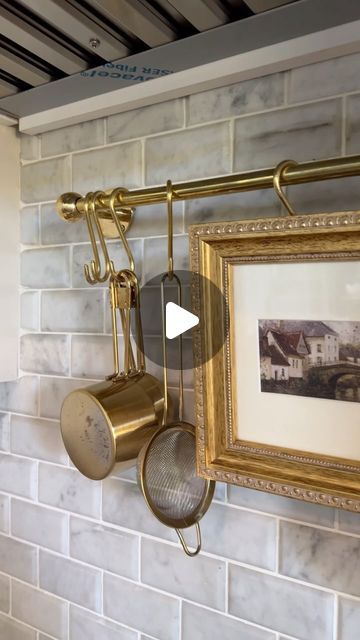 Fariha Nasir (Fa-ree-ha) on Instagram: "Install a brass rail in your kitchen - hang copper pots and pans under your vent hood and live out your cottage core dreams 💁‍♀️ comment SHOP and I’ll DM you all the supplies (if you’re not following me you won’t see the links in your DMs, they’ll be in the others folder) or, you can find all the links in my link in bio (Amazon storefront or shop LTK)

I stirred quite the drama in stories with this brass rail but the verdict is I’m going to find bigger pots to balance the look. Appreciate you guys managing my anxiety through the process 💀

#interiordesign #kitchenmakeover #diybrassrail #cottagecore #kitchendiy" Above Stove Ideas Decor, Vent Hood Shelf, Bundt Pans On Wall, Pot Rack Behind Stove, Brass Hanging Rail Kitchen, Wall Mount Pot Rack, Copper Pots Above Stove, Brass Rail Kitchen, Hanging Pots And Pans On Wall