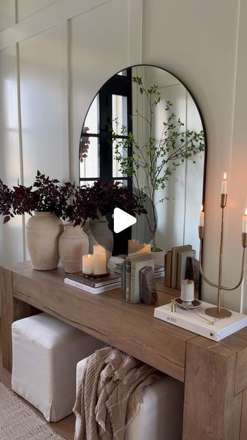 Leah White on Instagram: "Comment SHOP for the links for my entryway console table refresh!   I recently snagged this oversized mirror for a great price, which prompted me to restyle my entryway console table!  I’m loving this simple, warm and cozy look for transitioning to fall and cooler temps 🍂   SAVE + SHARE this styling inspiration and FOLLOW white.at.home for more daily home inspo and finds 🤍🤍  #entryway #moderntraditional #consoletable #consoletabledecor #falldecor" Console And Mirror Entryway, Entryway Table With Arch Mirror, European Style Entryway, Entryway Table And Mirror Ideas, Entryway Table With Gold Mirror, Entry Table With Pictures Above, Console Table Organic Modern, Front Entrance Console Table, Entry Console With Mirror