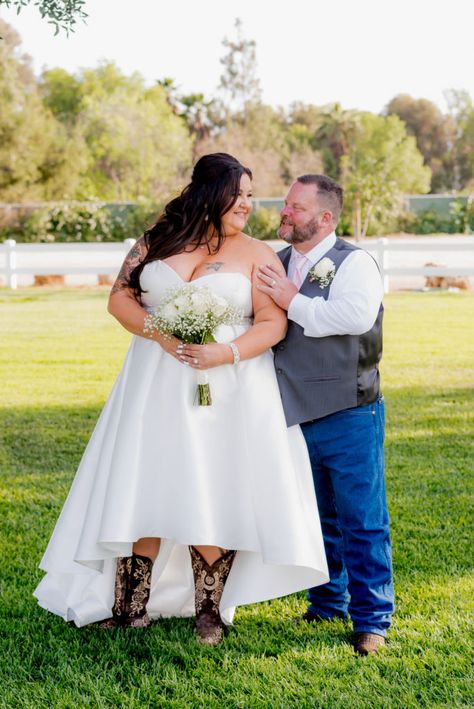 Cindy's Hi-Low Wedding Dress - Strut Bridal Salon  Hi low wedding dress with beaded belt is perfect for an outdoor wedding and shows off her boots perfectly!  #hiloweddingdress #boots #strutbridal #plussizeweddingdress #casualwedding #cowboyboots Short Wedding Dress With Boots, Bridesmaids In Boots, Wedding Dresses With Boots, Short Country Wedding Dress, Hi Lo Wedding Dress, Hi Low Wedding Dress, Dream Country Wedding, Country Wedding Gowns, Dresses With Boots