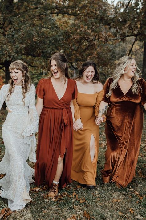 Bride in boho wedding dress with her three bridesmaids in different warm fall colored dresses. Fall Wedding Flower Girl, Fall Bridesmaid Dress Colors, Bridesmaid Dresses 2023, Bridesmaid Dresses 2024, Copper Bridesmaid, Copper Bridesmaid Dresses, October Wedding Dresses, Fall Bridesmaid, Maid Of Honor Dresses