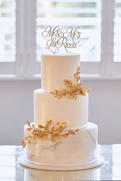 Wedding Cake Ideas Elegant Gold, Elegant White And Gold Cake, 2 Tier Wedding Cakes Simple Elegant Gold, Gold Flake Wedding Cake, Wedding Cakes White And Gold, White And Gold Cake Wedding, Gold Wedding Cake Designs, Wedding Cake 3 Tier Elegant, Wedding Cake Designs Elegant Gold