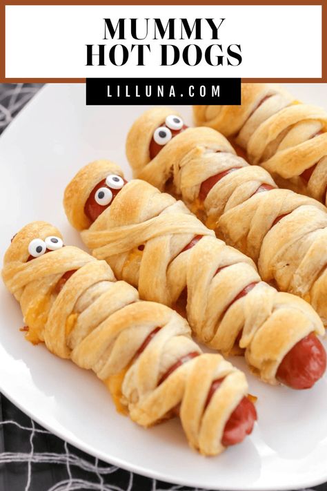 Buttery crescent-wrapped mummy hot dogs are filled with cheese and topped with cute candy eyes for spooky kid-friendly fun!! #mummydog #mummyhotdog #halloween #halloweendinner #halloweenappetizer Mummy Hot Dogs Crescent Rolls, Halloween Party Platter, Halloween Mummy Hot Dogs, Halloween Mummy Dogs, Mummy Hot Dogs Recipe, Fun Halloween Party Food, Mummy Hot Dogs, Pasteles Halloween, Mummy Dogs