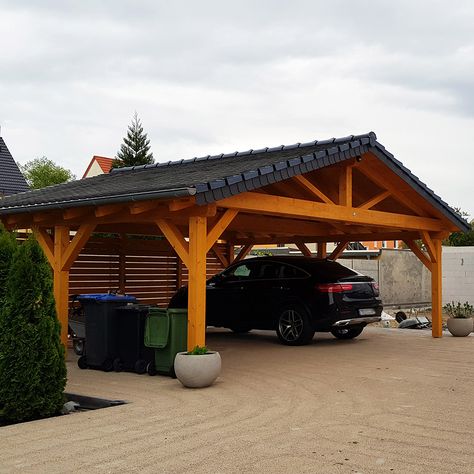 A car parks in the shelter of a wooden carport. Plan Carport, Carport Addition, Carport Makeover, Covered Carport, Metal Carport Kits, Wooden Carports, Building A Carport, Portable Carport, Diy Carport