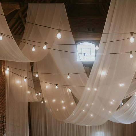 Aimee - WEDDING STYLING, COORDINATION & PROP HIRE on Instagram: "NO WORDS // because when images are as beautiful as this they’re sometimes not needed 🤍 Event Planning and Design // @wildeandvine Photography // @loveinbloom_weddings Venue // @godwickhall @godwickweddings Signage // @bewilderly Table Stationery // @rosewood_co Frames // @the.blissful.bride Textile Design + Fabric Installation // @miasylviaa & team @abbyspringham @allymfoster Floral Design // @wildeandvine Cake // @edge_by_imo Whimsical Ceiling Decor Wedding, Swagging Fabric Wedding Reception, Wedding Decoration Indoor Simple, Hanging Ceiling Decor Wedding, Fabric Installation Wedding, Drapery Wedding Reception, Wedding Party Decorations Indoor, Wedding Drapes Ceiling, Balloons At Wedding