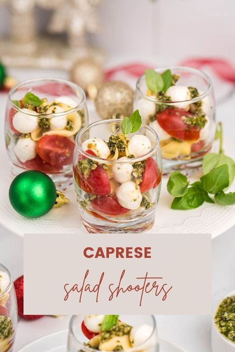 Make your holidays more fun with these Caprese Salad Shooters! The perfect side dish or appetizer for your next gathering, these bite-sized treats are sure to be a hit with family and friends! Packed with juicy tomatoes, fresh mozzarella, and a zesty balsamic glaze, these Caprese Salad Shooters are the perfect way to add a little extra fun to your holiday celebrations! #capresesaladshooters #sideorappetizer #holidaysnacks Caprese Salad In A Cup, Caprese Salad Skewers Appetizers, Individual Caprese Salad Cups, Cesar Salad Cups For Party, Caprese Salad Cups, Mini Salads In A Cup, Shooter Appetizers, Antipasto Cups, Veggie Shooters