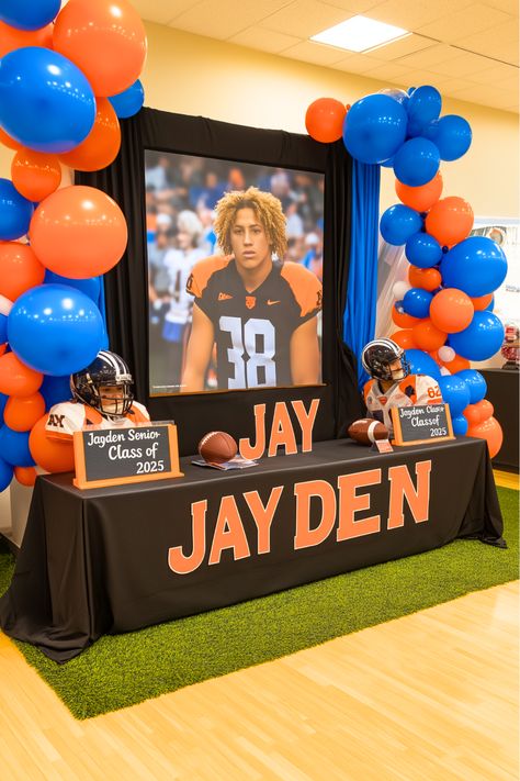 Want to relive your best football moments in style? Picture your senior display table featuring a projector screen that showcases your highlight reel. It’s the perfect way to bring your football achievements to life while keeping your audience entertained. Add some photos and memorabilia to complete the look. Make your senior night unforgettable with this interactive idea! College Signing Table Ideas, Football Banquet Table Decorations, Senior Table Ideas Sports Basketball, Senior Basketball Table Ideas, Senior Night Basketball Table Ideas, High School Senior Night Ideas, Senior Night Table Ideas Volleyball, Basketball Senior Night Decorations, Senior Sports Night Ideas