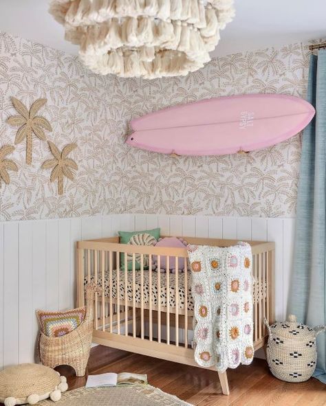 Cute girly baby nursery with a pink surf board Beachy Themed Nursery, Pink Palm Nursery, Florida Themed Nursery, Under The Sea Baby Girl Nursery Ocean Themes, Beach Inspired Nursery, Pink Beach Nursery, Pink Coastal Nursery, Boho Beach Nursery Girl, Beachy Nursery Ideas