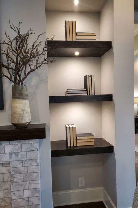 Light up your home decor with floating shelves that offer more than just storage. Our blog post explores 14 chic designs that incorporate lighting to create ambiance and highlight your favorite items. #GoTinySpace #FloatingShelveswithLights #ModernHome #DecorTips #Shelfie Corner Shelves Living Room With Lights, Floating Bookshelves With Lights, Built In Shelf Lighting, Led Lights On Floating Shelves, Backlit Shelves, Floating Shelves By Fireplace, Shelves With Lighting, Modern Floating Shelves With Led Lights, Niche Living Room