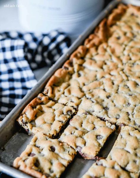 Rich and chewy sheet pan chocolate chip cookie bars have thick, crusty edges and a soft, chocolatey center. Easy to make and faster than traditional cookies! Picnic Food For A Crowd, Soft Chocolate Chip Cookie Bars, Sheet Pan Bars, Sheet Pan Cookies, Pan Bars, Chocolate Chip Pan Cookies, Easy Cookie Bars, Blondies Recipes, Work Treats