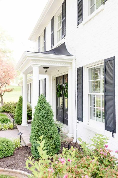 Simply White paint color (Benjamin Moore) on house exterior with black shutters - Julie Blanner. #simplywhitepaint #whitehouseexterior #paintcolors #housecolors White Exterior Brick, Brick House Paint Colors, White House Exteriors, Warm White Paint, White Brick House, Cream Paint Colors, Colonial House Exteriors, White Exterior Houses, Painted Brick House