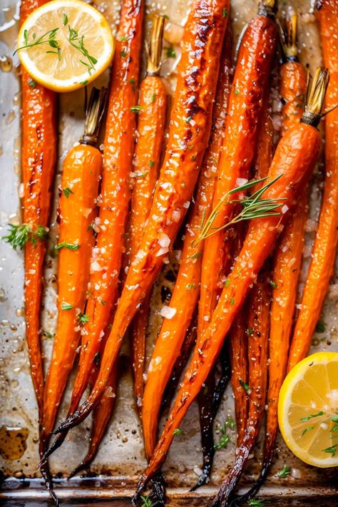 Got 30 minutes? That's all it takes for these oven-roasted maple carrots! Perfectly caramelized, with a hint of brown sugar sweetness, these carrots are the ultimate holiday side. Easy prep, unforgettable taste. Click for this quick, delicious recipe! Cooking Fresh Carrots, Roasted Glazed Carrots Recipe, Roasted Carrot Sticks, Paleo Glazed Carrots, Carmalized Carrots Oven, Best Roast Carrots, Carrot Stems Recipe, Rosemary Carrots Roasted, Fall Roasted Carrots