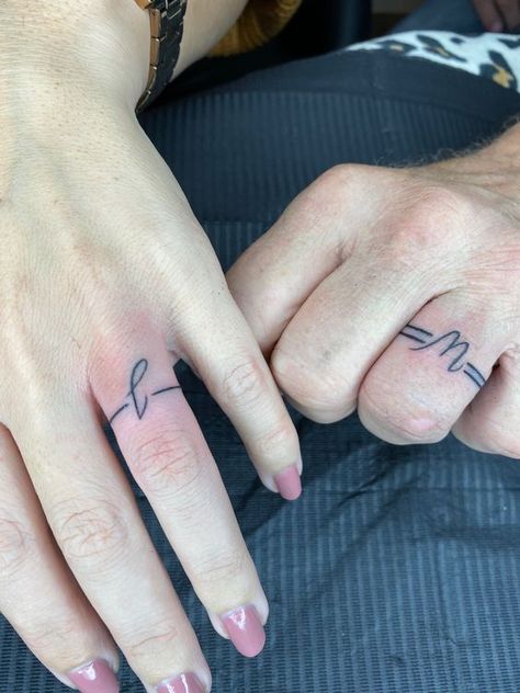 50 Unique Couple Tattoo Ideas For Expression of Love Unique Couple Tattoo, Couple Ring Finger Tattoos, Wedding Ring Finger Tattoos, Wedding Ring Tattoos, Marriage Tattoos, Finger Tattoos For Couples, Ring Tattoo Designs, Wedding Band Tattoo, Couple Tattoo Ideas