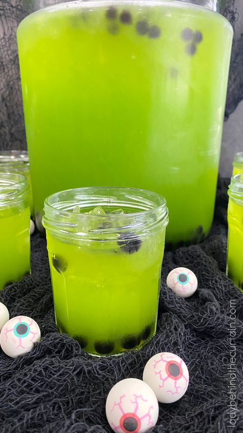 Halloween Party Slime Eyeball Punch: A simple traditional punch recipe transformed into a creepy punch filled with floating gummy eyeballs. This boba punch Halloween Punch With Eyeballs, Slime Punch Recipe, Halloween Punch Bowl Ideas, Halloween Boba Drink, Neon Punch, Diy Halloween Punch Bowl, Zombie Punch, Halloween Boba, Halloween Punch Bowl