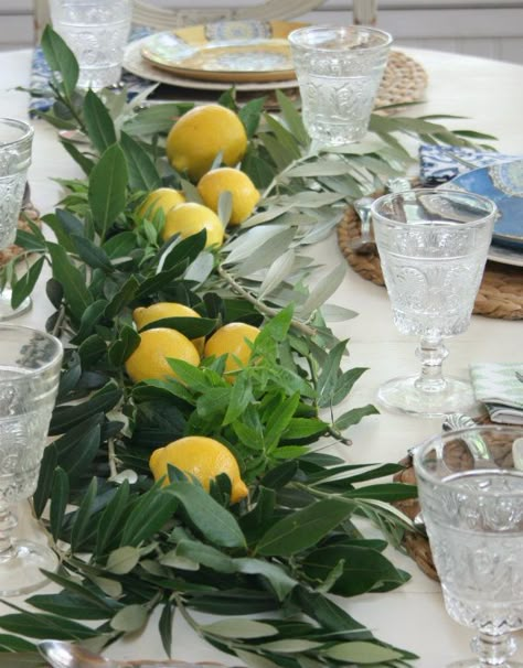 Layer fresh herbs down the center of the table  and finish off with a few lemons placed on top of the  fragrant herbs. Italian Lunch Table Setting, Italian Style Table Decor, Faux Florals Wedding, Italian Inspired Table Setting, Italian Aesthetic Party, Italian Dinner Party Table Settings, Italian Rehersal Dinner Theme, Italian Table Decorations Dinner Parties, Italian Anniversary Party Ideas