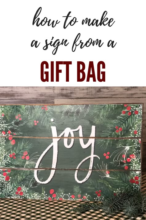 Gift Bag Crafts, How To Store Gift Bags, Dollar Tree Gift Bag Crafts, Trending Christmas Crafts 2022, Christmas Gift Bag Wall Art, Painted Christmas Signs, Diy Christmas Signs, Dollar Tree Sign Makeover Christmas, Christmas Signs And Sayings Wreaths & Garlands