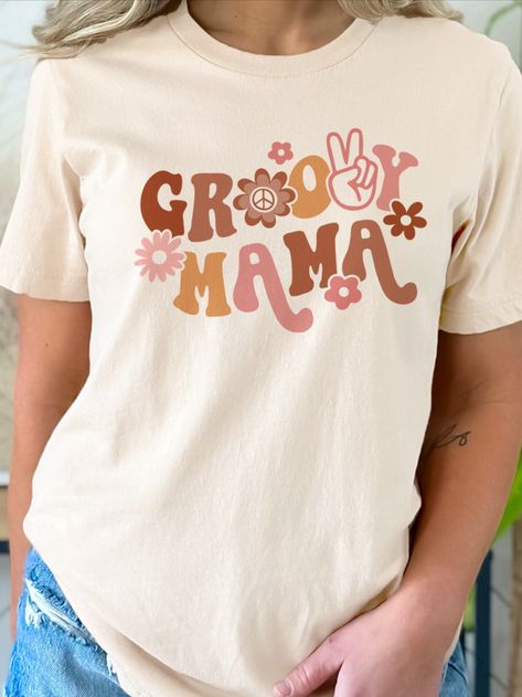 Get groovy with our Retro Groovy Mama T-Shirt! With a classic fit and high-quality materials, this shirt is perfect for any stylish mom who loves retro vibes. Whether you're out and about or just relaxing at home, this t-shirt is a must-have for any trendy mama. Don't miss out - get your Retro Groovy Mama White T-Shirt today! #groovymamashirt #getgroovyshirt #giftformmom #retro70shirt #retromomshirt Groovy Mama Shirt, Groovy Tshirt, Decoration Ideas Birthday, Groovy Mama, 2nd Birthday Party For Girl, Groovy Shirt, Birthday Party Theme Ideas, 70s Shirts, Aesthetic Hoodie