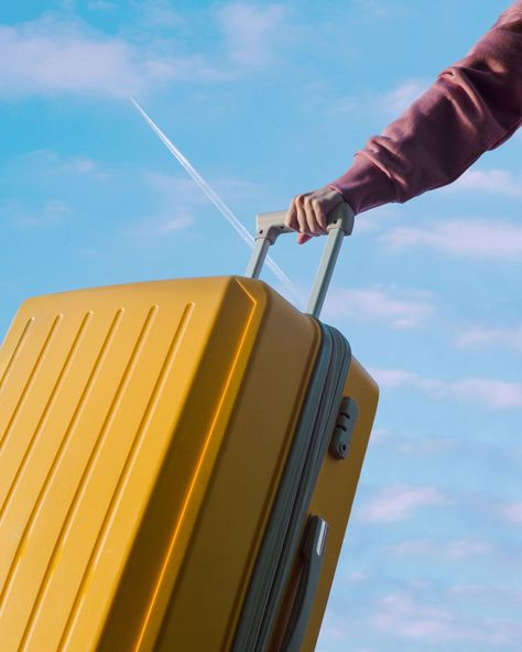 An unrecognizable person holds a travel yellow plastic suitcase by the handle against a blue sky Luggage Photography, Plastic Suitcase, Stay In The Moment, Viking Cruises, Sea Boat, Suitcase Packing, American Tourister, The Tourist, Training Day