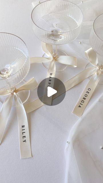 CREO on Instagram: "I’m in loveeee… personalised ribbons 🤍🥂   Everyone is loving bows and ribbons this season, and I adore this trend for event decor. So I am now offering these gorgeous satin ribbons, with heat pressed vinyl names.   The ribbons can be used in many ways; - Place settings / alternatives for place cards - Bridal party gifts - Drinks tags - Wedding bouquet accessories  - Gift wrapping - Branding  Shop this particular size and style online now, or contact me to request any custom size and colour scheme 🎀 . . . #weddingstationery #bowseason #personalisedribbon" Name Tags At Wedding, Personalized Ribbon Wedding, Bows In Wedding Decor, Ribbon Name Tags Wedding, Wedding Name Place Cards Ribbon, Ribbon Name Cards Wedding, Bow Wedding Details, Bow Place Setting Wedding, Bow Name Place Cards