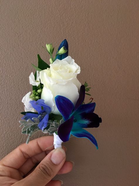 Boutineer Ideas Prom Royal Blue, Royal Blue Boutonniere, Blue Prom Flowers Bouquets, Blue Boutineer, Dark Blue Corsage, Prom Flowers Bouquet Royal Blue Dress, Black And Blue Corsage And Boutonniere, Corsage And Boutonniere Set Blue, Blue Delphinium Boutonniere