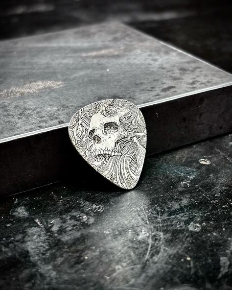 The ghoulish strummer Another guitar pick from yesterday’s batch. Made out of 20g spring hard .925 sterling silver . . . . . . . . #guitarpick #silver #sterlingsilver #ghoulish #guitarist #guitar #skull #personalized #customguitarpicks #musician #gift #giftidea #giftideas #sooke #sookebc Cool Guitar Picks, Silver Guitar, Custom Guitar Picks, Skull Style, Steel Guitar, Skull Fashion, Silver Engraving, Guitar Picks, Bc Canada