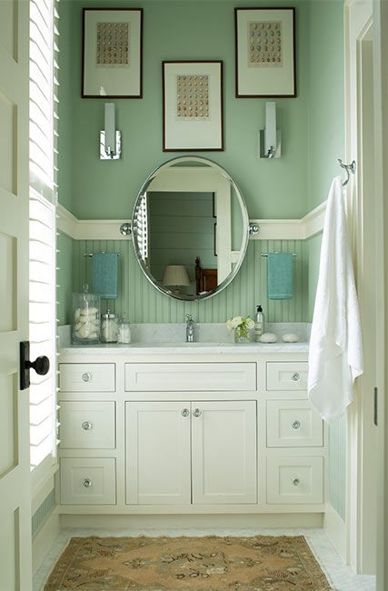 A green-painted bathroom with white built in sink cabinets and marble countertop. Interior Green Paint Colors, Green Interior Paint Colors, Seafoam Green Bathroom, Green Interior Paint, Benjamin Moore Green, Rustic Paint Colors, Interior Paint Ideas, Bathrooms Mirrors, Most Popular Paint Colors