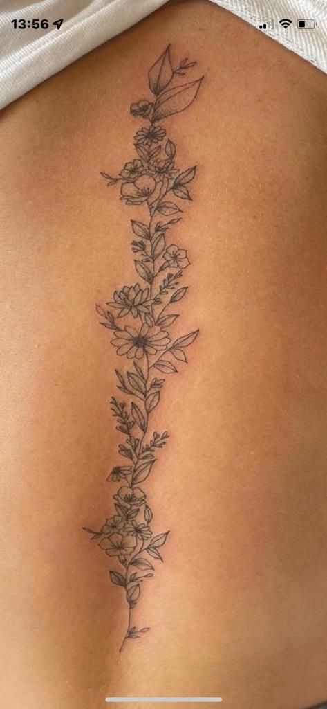 Flower Tattoos Down Spine, Flowers And Vines Spine Tattoo, Flower Tattoos Back Spine, Spin Flower Tattoos For Women, Flower Vine Tattoos Spine, Daisy And Vine Tattoo, Back Floral Tattoo Spine, Flower Down Spine Tattoo, Flower Spinal Tattoo Women