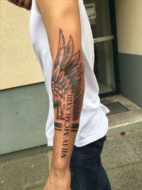 roman-numerals-arm-tattoo-fallen-angel-tattoo-angel-wing-man-with-white-top-jeans Wing Tattoos On Back, Wing Tattoo Men, Small Wave Tattoo, Back Of Arm Tattoo, Tattoo Placements, Female Tattoos, Forarm Tattoos, Men Tattoos, Tattoo Inspiration Men