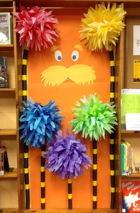 The Lorax is peeking out behind truffula trees in the Children's Area of the Mt. Healthy branch. I wonder if Dr. Seuss books can be found nearby? Dr Seuss Trees, Dr. Seuss Door, Dr. Suess, Dr Seuss Classroom Door, Halloween Classroom Door, Dr Seuss Classroom, Dr Seuss Activities, Dr Seuss Crafts, Minion Halloween