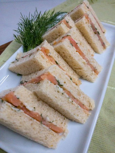 This addicting tea sandwich features a homemade herb butter and delicate smoked salmon. Smoked Salmon And Dill Sandwich, Tea Sandwiches Salmon, Salmon Tea Sandwiches Recipes, Winter Tea Party Sandwiches, Salmon Sandwich Ideas, Turkey Tea Sandwiches, Smoked Salmon Tea Sandwiches, Salmon Tea Sandwiches, Salmon Sandwich Recipes