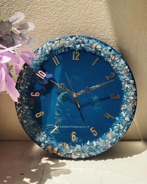 Teal colour supremacy 🦋!!! Made this sparkling wall clock recently and got a cut from the glass chunks too 🤣!! Size : Diameter: 14 inch Width : 30mm Colour : Ash gray Dm us for more information 🦋 [ Wall clock , interior design, Resin clock ,custom gift , corporate gifting , bulk order ,diwali gifting , gift for home , gift for family , resin workshop ] #resinart #wallclock #interiordesign #bulkorder Clock Interior Design, Resin Art Wall Clock, Resin Workshop, Resin Art Clock, Clock Living Room Decor, Epoxy Wall Art, Clock Resin, Epoxy Wall, Resin Wall Clock