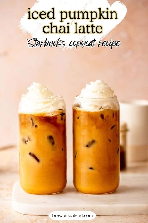 Two iced pumpkin chai lattes topped with whipped cream sitting on a marble slab. Pumpkin Chai Latte Starbucks, Pumpkin Chai Latte Recipe, Pumpkin Chai Tea Latte, Chai Latte Starbucks, Pumpkin Chai Latte, Pumpkin Chai Tea, Copycat Drink Recipes, Cold Drinks Recipes, Chai Latte Recipe