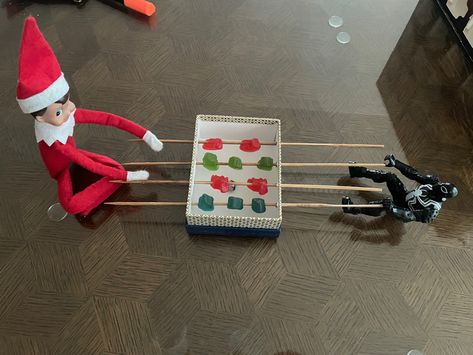 Foosball using Christmas theme gummies and a jjnglebell for the ball. Football Elf On The Shelf, Elf On The Shelf Gummy Bears, Elf On The Shelf Marshmallow Igloo, Elf On The Shelf Toasting Marshmallows, Elf On The Shelf With M&ms, Elf 2024, Foosball, Elf Fun, Elf Ideas