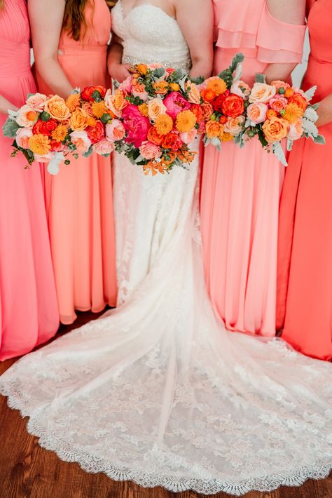 Don't fear color when it comes to wedding fashion and flowers. These coral and pink mismatched bridesmaids dresses added personality to the celebration and matched the stunning pink and orange bouquets perfectly. This is a stunning color palette for those spring or summer weddings. | John Myers Photography & Videography Pink Coral Bridesmaid Dresses, Bridesmaid Dresses Not Matching, Red Orange Purple Pink Wedding, Pink Peach Orange Wedding, Pink And Orange Wedding Theme Groomsmen, Red And Coral Wedding, Orange And Pink Wedding Flowers, Red Pink Orange Wedding, Coral Peach Bridesmaid Dresses