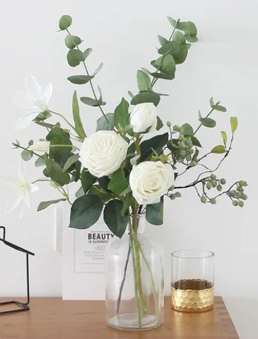 White Flowers With Eucalyptus Centerpieces, White And Green Flowers Baby Shower, Easy Eucalyptus Centerpiece, Small Eucalyptus Centerpieces, Floral Vase Centerpieces, Eucalyptus Bridal Shower Centerpiece, Neutral Table Decor Wedding, Eculyptus Centerpiece Wedding, Minimalistic Flower Arrangements