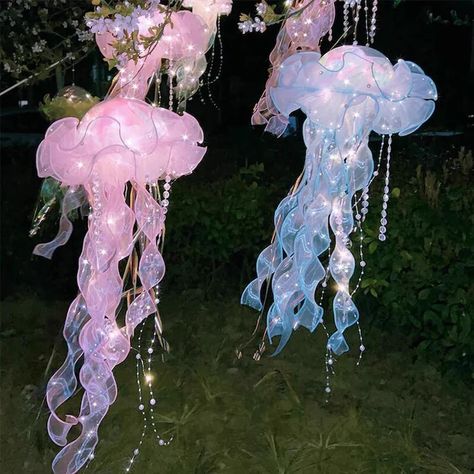 pink and blue jellyfish lanterns at night, hanging from a pink flowering tree Lantern Fairy Lights, Diy Jellyfish Decoration, Kokomi Cosplay, Jellyfish Lights, Jellyfish Haircut, Pirate Halloween Party, Jellyfish Tentacles, Hanging Jellyfish, Jellyfish Lantern