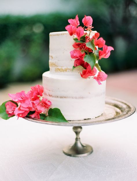 A white naked wedding cake with bougainvillea Bougainvillea Cake, Hawaiin Wedding, Bougainvillea Wedding, Tropical Wedding Cake, Jamaican Wedding, Wedding Color Palette Summer, Mediterranean Wedding, Floral Wedding Cake, Floral Wedding Cakes