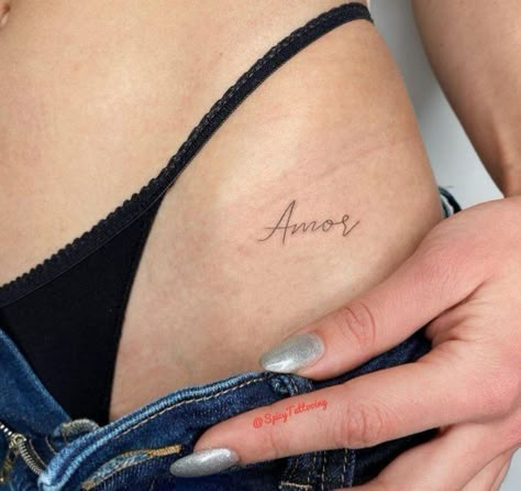 Italian Word Tattoos For Women, Amor Tattoos For Women, Small Intimate Tattoo, Side Bum Tattoo, Amore Tattoo Fonts, December Tattoos Ideas, Intimate Tattoos For Women, Amor Tattoo, Tiny Tattoos For Women