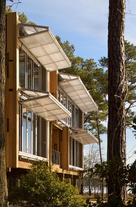 Hangar doors on the west facade can be tuned to the angle of the sun as it changes over the course of the day. Here, they are in the awni... Butterfly Pavilion, Passive House, Design Exterior, Pergola Shade, Facade Architecture, Facade Design, Design Case, Container House, Facades