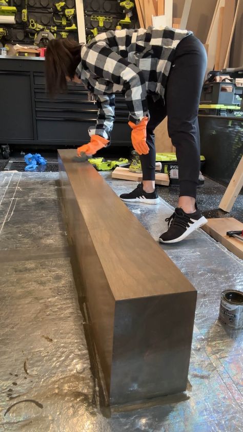 Melissa Tyler staining her DIY fireplace mantle. Staining Fireplace Mantle, Diy Floating Mantle Shelf, Replace Mantle With Wood, Build Mantle Fireplace, Black Fireplace Wood Mantle, Drywall Fireplace With Mantle, Diy Mantle Fireplace, Diy Floating Mantle, Diy Mantel Fireplace