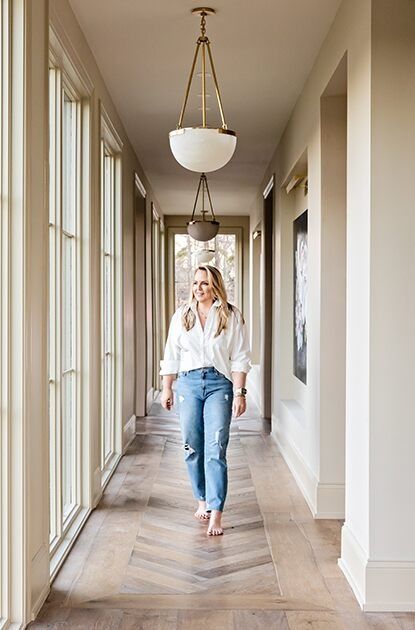 Lori Paranjape walks down a beige hallway with wood flooring and floor-to-ceiling windows. Best House Paint Colors, Bleeker Beige, Beige Hallway, Benjamin Moore Paint Colors, Cozy Bedroom Colors, Light Paint Colors, Neutral Curtains, Paint Colors Benjamin Moore, Benjamin Moore Colors