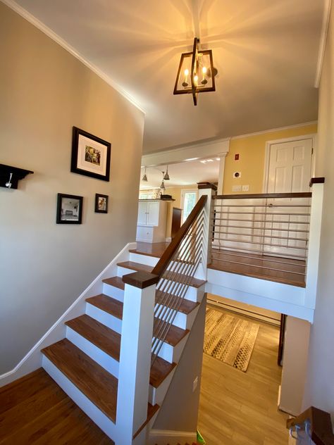 Stairs, railing and balusters replaced in this 1960s split level ranch to update the entryway. Walnut wood and stainless steel. Split Level Railing Ideas Entryway, Split Level Finished Basement Ideas, Staircase Makeover Split Level, Front Porch Design Split Level, Stair Railing Ideas Bilevel, Split Level Entryway Railing, Interior Stair Railing Ideas Split Level, Raised Ranch Railing Ideas, Split Entry Stairs