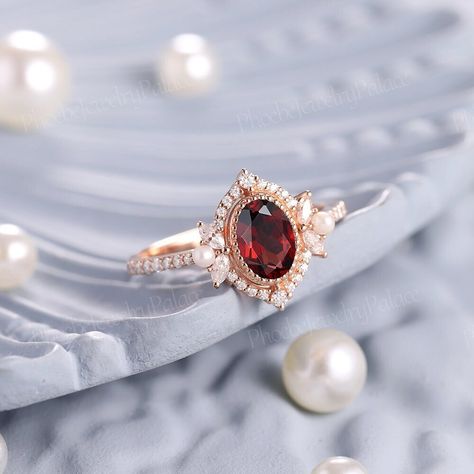 Vintage Oval Shaped Garnet and Pearl Engagement Ring Art Deco Ruby Filigree Solid Gold Wedding Ring Unique Birthstone Ring Anniversary Gift PRODUCT SUMMARY Metal Type: yellow, white or rose solid 14 or 18k gold. Size: All sizes are available, contact me if they do not contain the size you want in the drop-down menu. ☪☪Engagement ring ⚜Center Stone - Garnet Cut - Oval Size - 7x5mm ⚜Side Stone - Moissanite Cut - Round Weight - 0.33ct Clarity - SI-VS Color- G-H ⚜Band width - 1.8mm This ring work wi Elegant Oval Cabochon Ruby Ring For Wedding, Exquisite Oval Ruby Ring For Wedding, Exquisite Oval Ruby Wedding Ring, Fine Jewelry Wedding Ruby Ring With Oval Cabochon, Wedding Ruby Ring, Oval Cabochon, Fine Jewelry, Fine Jewelry Oval Cabochon Ruby Wedding Ring, Oval Cabochon Ruby Ring For Wedding, Exquisite Ruby Ring With Accent Stones For Wedding, Exquisite Ruby Ring With Gemstone Accents For Wedding