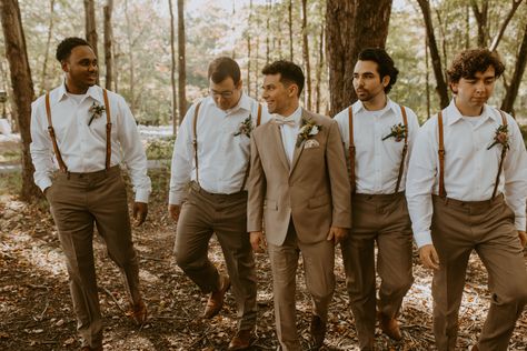 in the woods, party of 4 groomsmen and the groom, groom is in tan suit with champagne bowtie, groomsmen wearing tan pants and white button-up shirt with leather suspenders Groomsmen White Shirt Khaki Pants, Fall Wedding Groomsmen Attire, Wedding In 3 Months, Tan Groomsmen Suits, Fall Groomsmen, Tan Groomsmen, Tan Suit Wedding, Fall Wedding Groomsmen, Brown Groomsmen