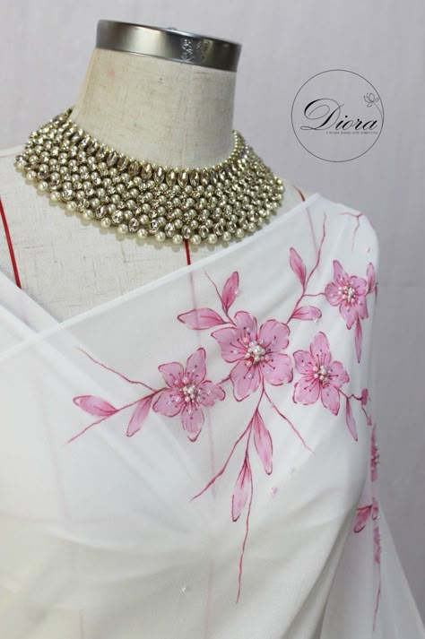 #diora #dioraembroidery #dioraapparel #details  #handpaintingsaree #embelishment #handembroidery #designersaree #engagement #engagementbride #bridalsaree  #designerdress #uniquebeauty #elegance #Emergingbrand #2022yearendparty #simplicity  #christmas2022 #yearendwedding #december  #decemberwedding #pinkflowers #flowers #2023calendar #2023weddings  #fairytalewedding #fairytale #srilankanweddings #srilankanbrides #srilankansarees Hand Painting On Fabric, Hand Printed Saree, Hand Painted Saree, Fabric Colour Painting, Fabric Painting Ideas, Painted Saree, Fabric Paint Shirt, Saree Painting Designs, Painting On Fabric