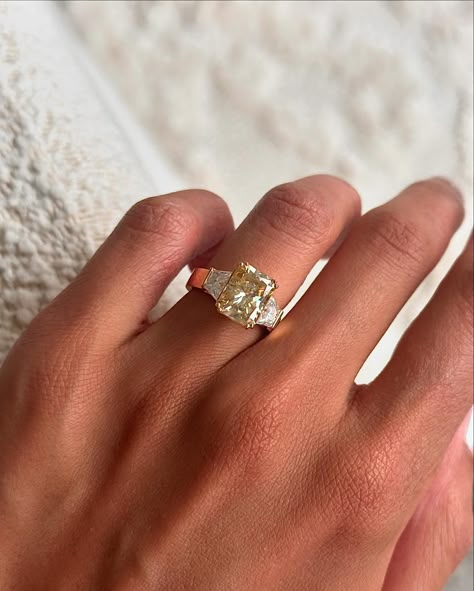 Adore this recent bespoke creation, featuring a 3.1ct radiant cut champagne moissanite, a flat wide band, and trapezoid accent stones 🤍 Details: - 3.2ct radiant moissanite - 2x 0.5ct trapezoid moissanites - 18k yellow gold - 3.9mm wide shank Engagement Ring With Epaulettes, Vintage Yellow Diamond Ring, Radiant Vs Cushion, Trilogy Engagement Ring And Wedding Band, Wide Band Wedding Rings, Engagement Rings Yellow Diamond, Multi Stone Engagement Ring, Cool Engagement Rings, Yellow Diamond Engagement Rings